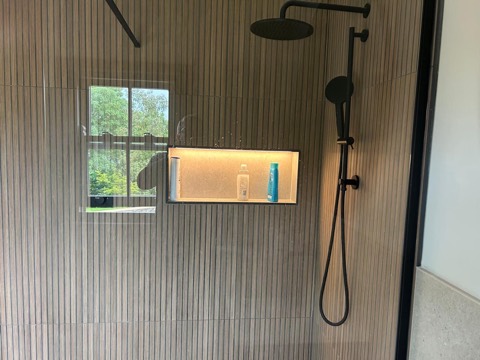Rainfall shower, textured tiles and an illuminated recessed niche
